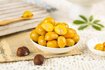 Roasted Chestnuts in Bowl on Vintage Newspaper - Healthy Autumn Snack Food Photography