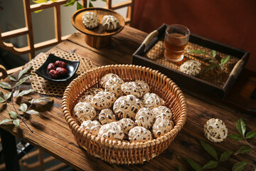Dried Shiitake Mushrooms in Wicker Basket on Wooden Table with Asian Tea Set - Traditional Culinary Ingredients