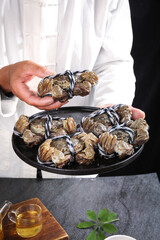 Chef presenting fresh Yangcheng Lake hairy crabs closeup in professional kitchen