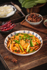 Stir-Fried Bamboo Shoots with Scallions and Asian Spices on Rustic Wooden Board