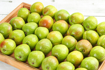 Fresh Xinjiang Green-Skinned Pears and Apricots in Wooden Basket - Organic Fruit Harvest Display