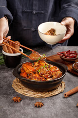 Braised Goose and Potato Stew in Clay Pot with Chopsticks and Traditional Asian Spices