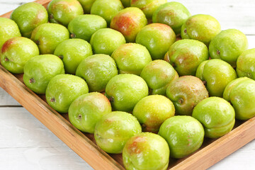 Fresh Green-Skinned Fruits in Wooden Crate Display - Natural Organic Produce