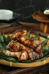 Fresh Wild Mushrooms in Bamboo Basket with Leaves and Natural Mud from Forest Harvest