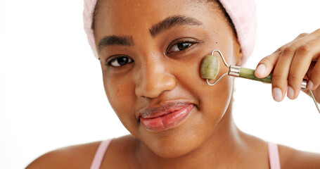 Black woman, jade roller and smile in studio portrait, beauty and circulation on white background. African girl, happy and facial massage for skincare, dermatology and lymphatic drainage in Nigeria