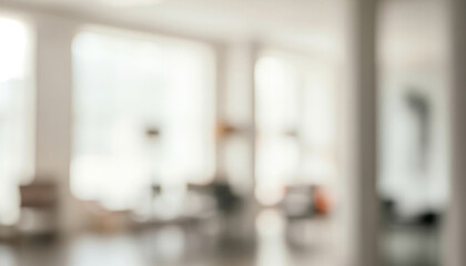 Blurred interior view of a bright room with large windows and furniture, filled with sunlight that enhances an inviting and uplifting atmosphere.