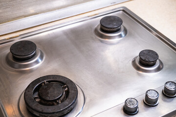 Polished gas cooker after washing. Perfectly clean gas cooker after being washed with polishing chemicals. The result of washing the burners.
