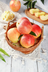 Fresh Red Gala Fuji Apples from Xinjiang First Crop Harvest in Wicker Basket on White Wooden Table