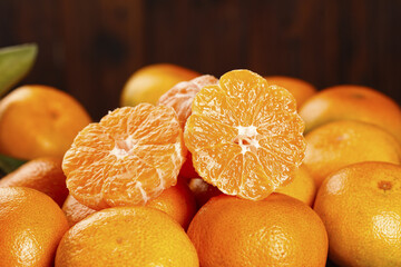 Freshly Peeled Tangerine Segments with Whole Citrus Fruits in Autumn Composition