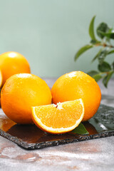 Fresh Navel Oranges on Slate Board with Slice - Healthy Citrus Fruit
