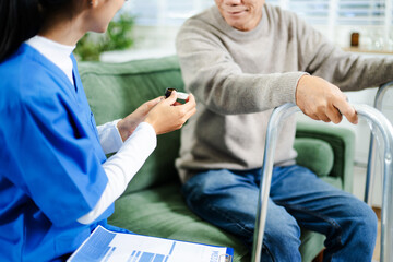 Professional caregiver supports elderly man with walker in home care setting  in healthcare concept of rehabilitation, trust, and mobility assistance.