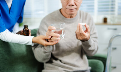 Caring nurse helps senior man take medication with water during home visit. in elderly healthcare, recovery, and pill management scene.