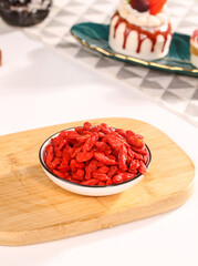 Dried Red Goji Berries Wolfberries Chinese Herbal Medicine Superfood Health Tonic on Wooden Board