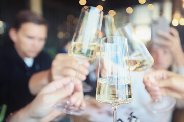 Friends with glasses of wine clink glasses holiday, a group of people abstract blurred background