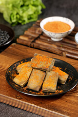 Yunnan Black Tofu Specialties Breaded with Spices on Iron Plate Traditional Chinese Cuisine