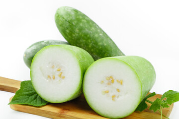 Fresh Mini Winter Melon Linglong Slices Display on Wooden Board with Green Leaves