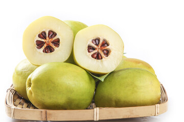 Fresh Yunnan Green Papaya Fruits with White Flesh Cross-Section in Bamboo Basket on White Background