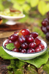 Fresh Red Grapes in Bowl with Vineyard Leaves - Organic Fruit Harvest