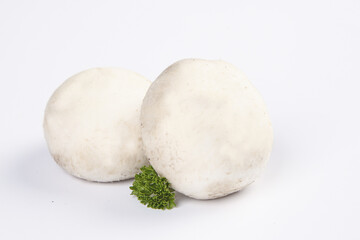 Fresh White Button Mushrooms with Parsley Garnish on White Background Studio Shot
