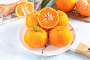 Fresh Orange Citrus Fruits on Plate with Mint Garnish - Healthy Vitamin C Rich Food Display