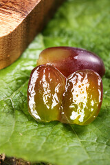 Fresh Ripe Fruit with Golden Translucent Pulp on Green Leaf Natural Organic Food Photography