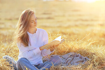 female reading a book in a field summer straw woman reading a book student studying summer vacation from school girl in the field