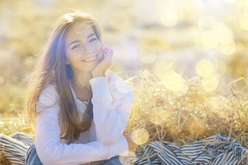 summer sunny portrait of a happy girl, female happiness sun glare straw field country style