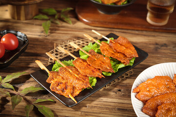 Grilled Chicken Skewers BBQ Tenders on Wooden Sticks with Lettuce Garnish