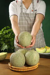 Chef Holding Fresh Hainan Cantaloupe Melon in Professional Kitchen