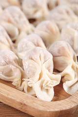 Fresh Homemade Dumplings on Wooden Cutting Board - Traditional Pasta Making