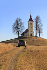 Car Driving towards Saint thomas Church, Slovenia