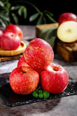Fresh Red Fuji Apples from Zhaotong Yunnan China on Slate Board with Mint Leaves