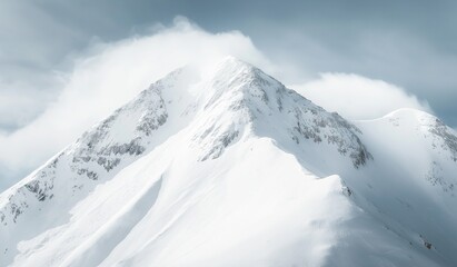 Pristine snow-covered mountain peak in sharp focus against cloudy sky, symbolizing grandeur and natural beauty with intricate snowy textures evoking awe for nature's majesty