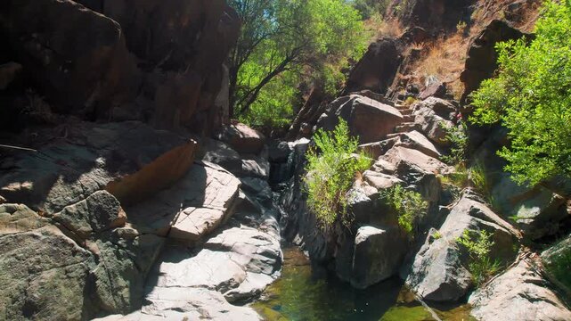 Charco las Vinas in Oj&eacute;n, Andalusia, Spain, aerial moving backwards to reveal the background