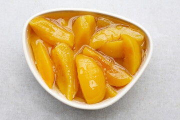 Sliced peaches in syrup served in a bowl