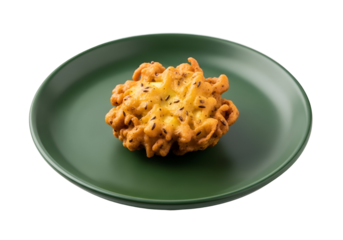 A single, golden-brown, intricately patterned fried snack sits attractively on a muted green plate against a black background.