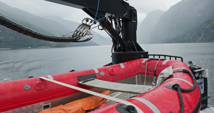 Rescue RIB on Norwegian fjord, rainy day ship deck with mountains and mist