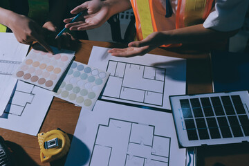 Closeup of team of industrial engineers meeting analyze machinery blueprints consult project on table in manufacturing factory. Working in manufacturing plant or production plant.