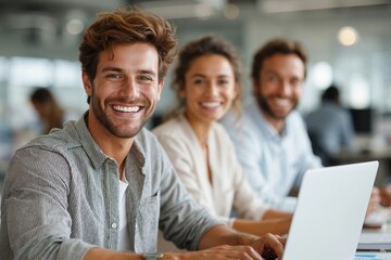 A group of people sitting around a table with a laptop computer