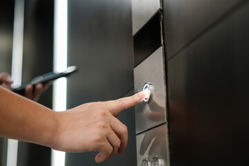 hand pressing an elevator button