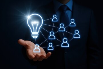 Illuminated lightbulb connected to network of people icons