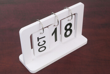 October, 18 on calendar on wooden background.	