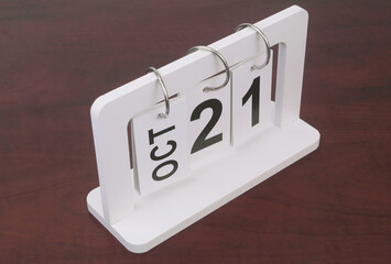 October, 21 on calendar on wooden background.	