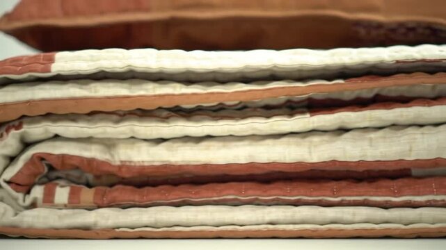 Cozy stack of folded quilted blankets