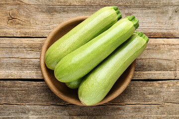 Fresh ripe zucchinis on wooden table, top view