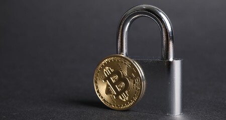 Bitcoin and padlock on grey background, closeup. Space for text