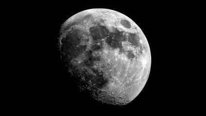 Obraz premium Close-up view of a gibbous moon against a black background. Detailed cratered surface visible