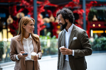 Business people talking and walking with coffee and smartphone
