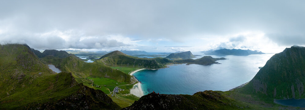 Explore the breathtaking landscape of Lofoten, Norway featuring the iconic Mannen mountain and Haukland Beach. The serene waters and dramatic sky create a stunning backdrop for nature lovers.