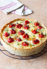 Quiche with cheese, tomatoes, and thyme. Pie. Pastries. Vegetarian food.